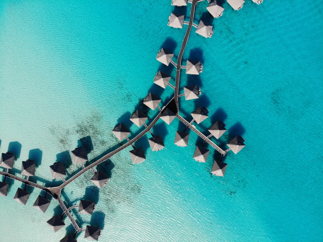 aerial view of white and gray boat on sea during daytime, Overwater Bungalows in Bora Bora, French Polynesia
