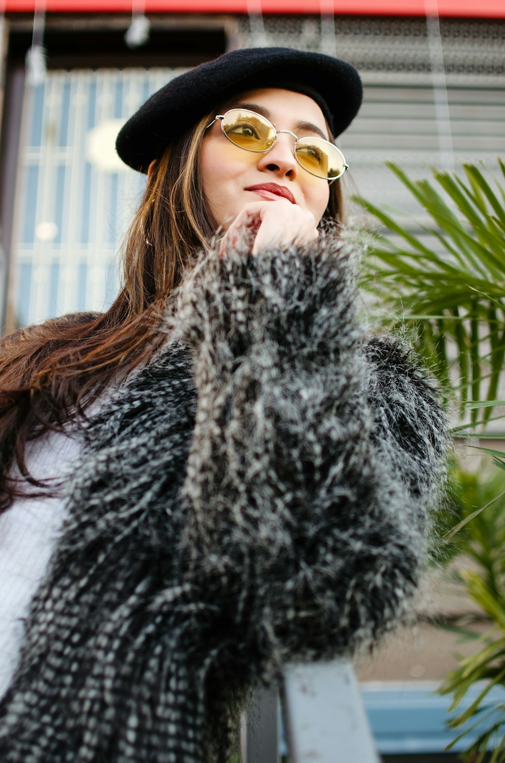 woman in black fur coat wearing sunglasses