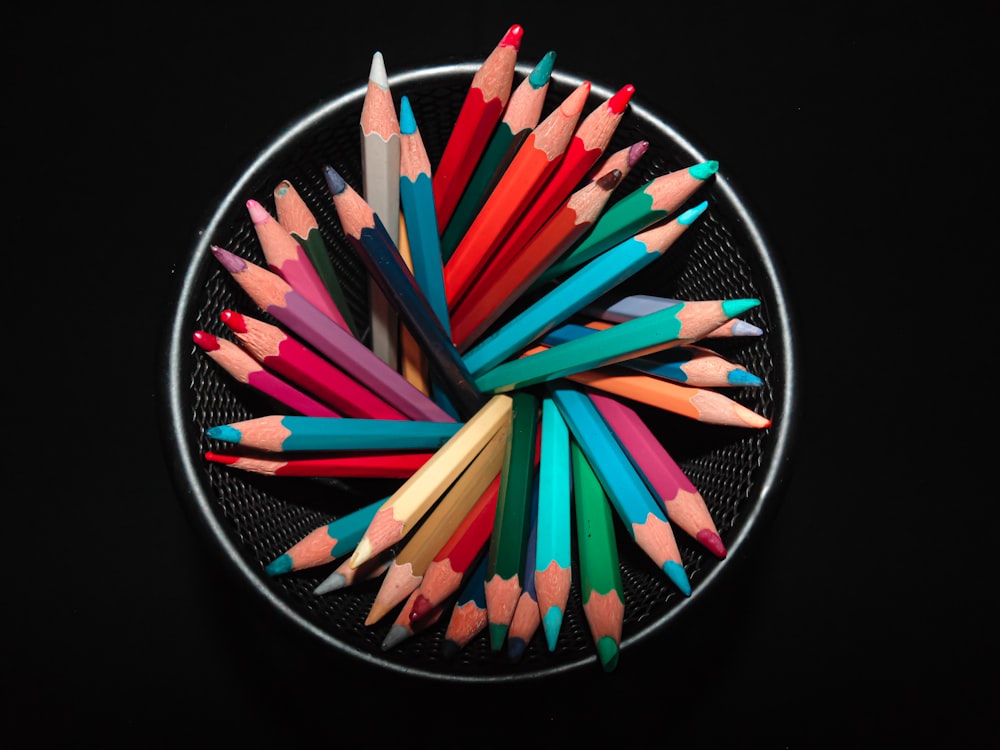 coloring pencils on black round container