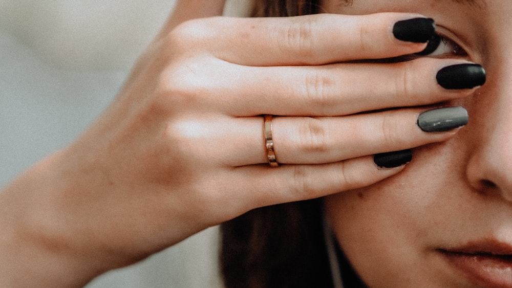 person wearing gold ring on ring finger