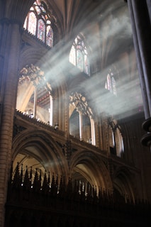 Sunlight streaming through stained glass windows illuminating the serene church interior.