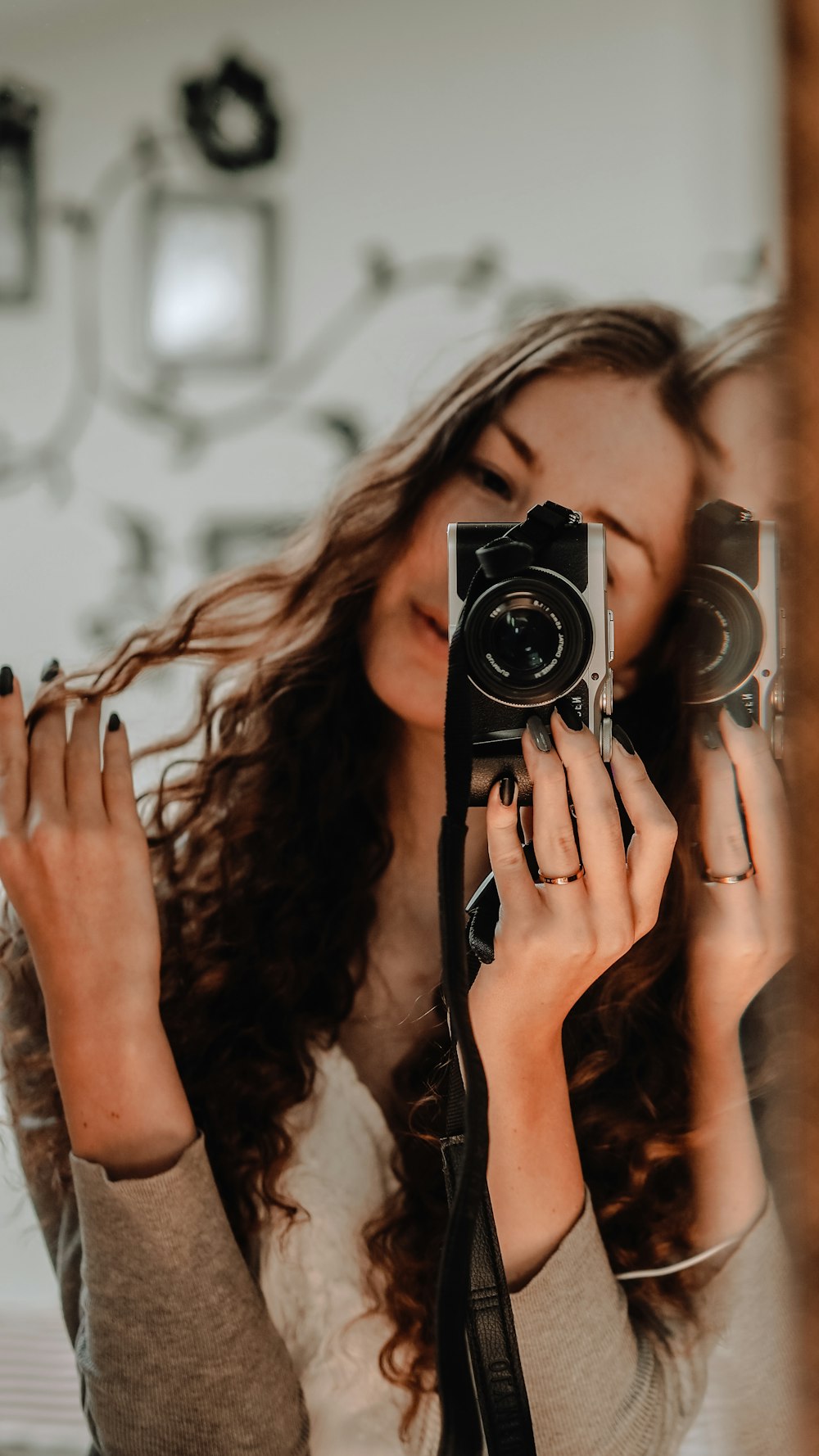 woman holding black and silver camera