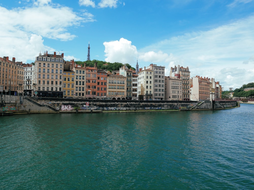 city buildings near body of water under blue sky during daytime