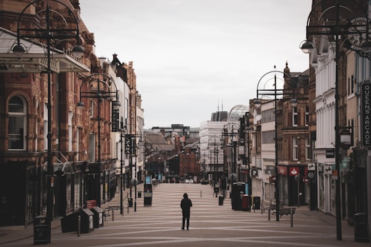 people walking on sidewalk near buildings during daytime in Leeds United Kingdom