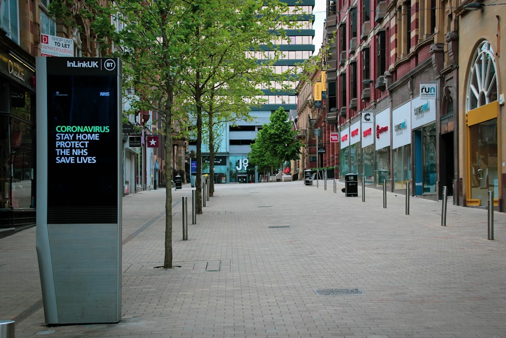 people walking on sidewalk near buildings during daytime