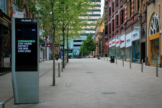 people walking on sidewalk near buildings during daytime in Leeds United Kingdom