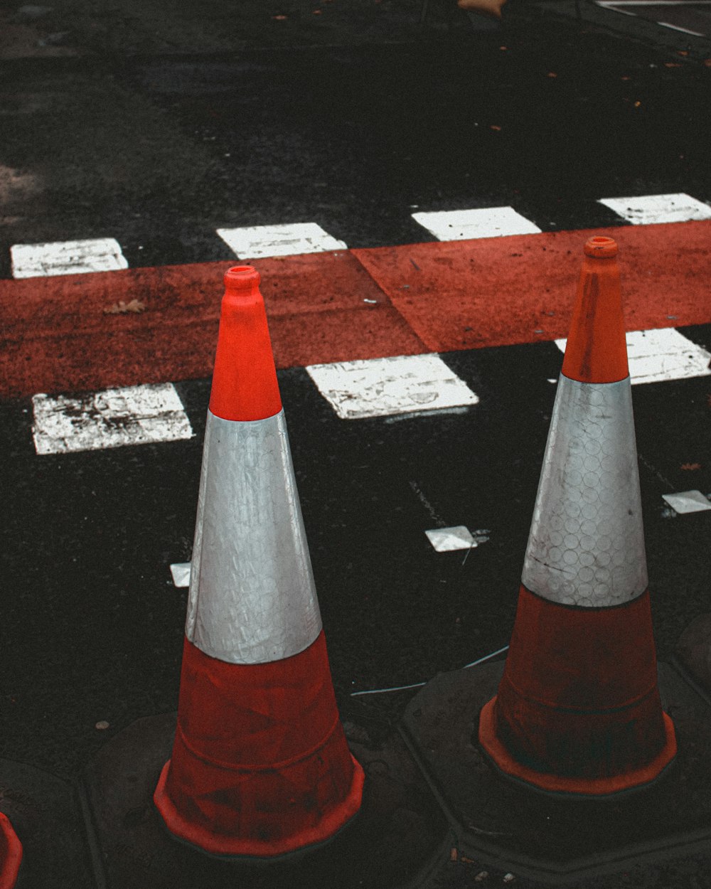 a group of traffic cones sitting on the side of a road