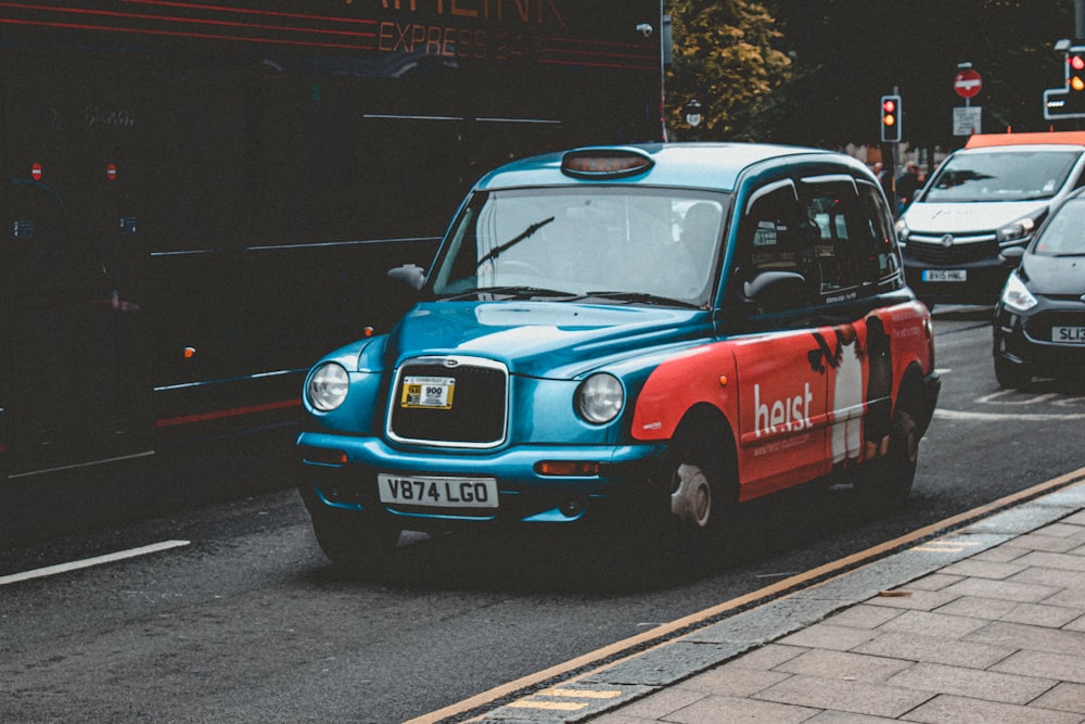 blue and red car on road