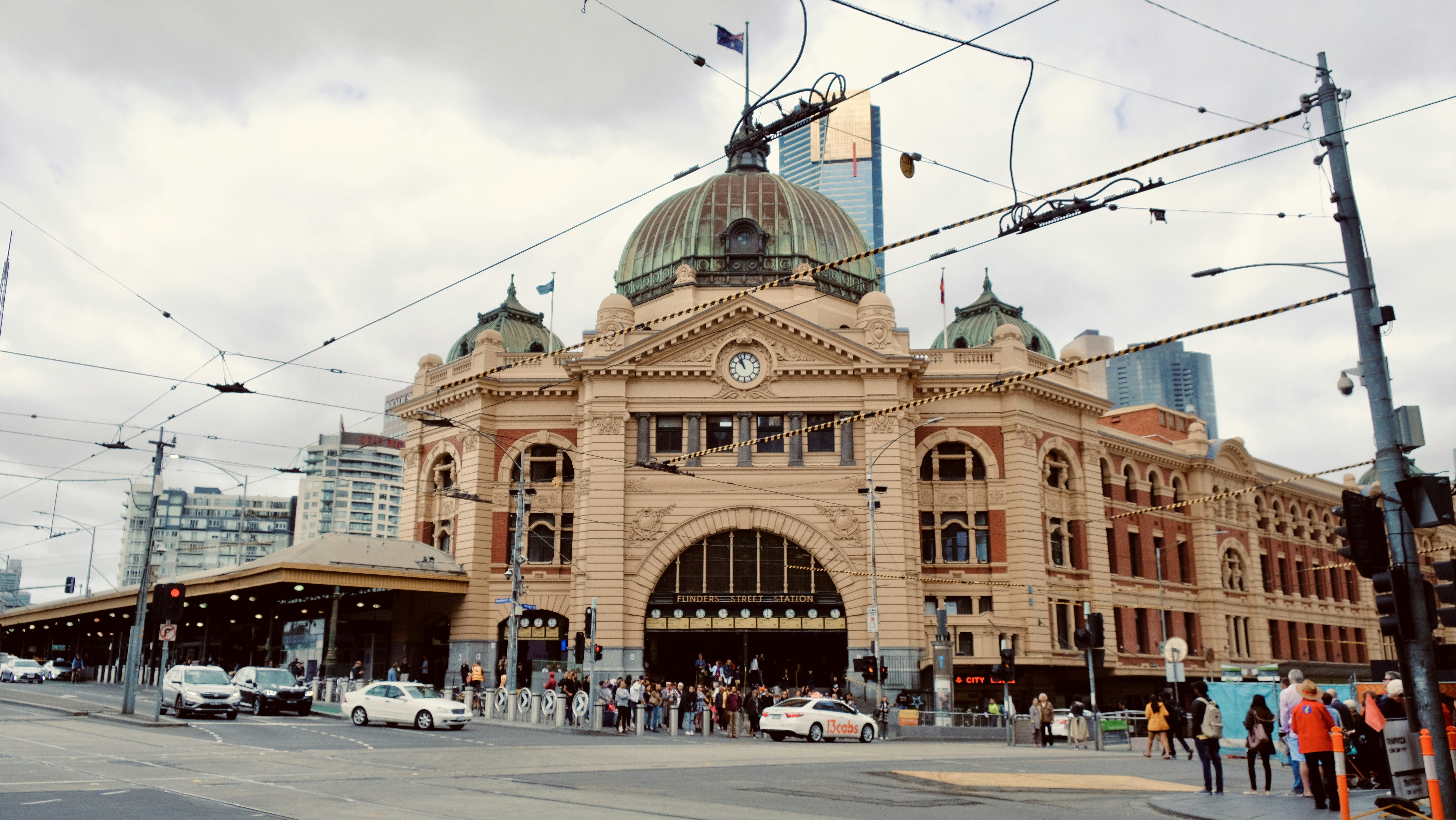 cars parked in front of brown concrete building during daytime