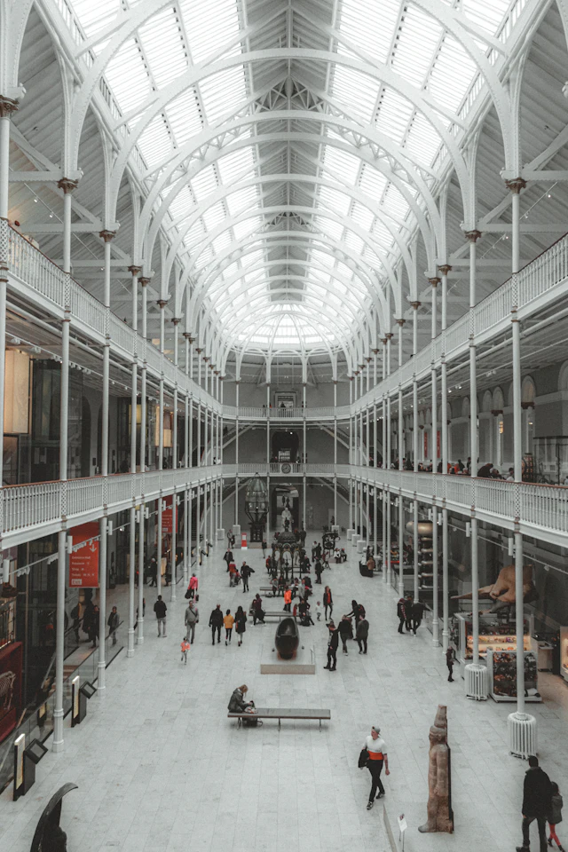 The white cast-iron Grand Gallery of the National Museum of Scotland, with visitors below