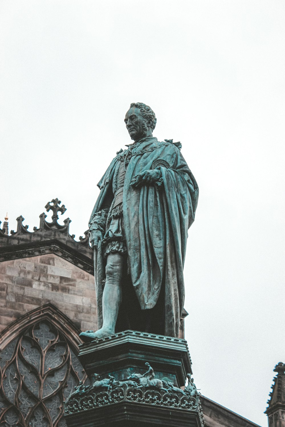 statue of man holding book