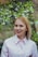 smiling woman in white dress shirt