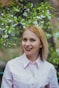smiling woman in white dress shirt