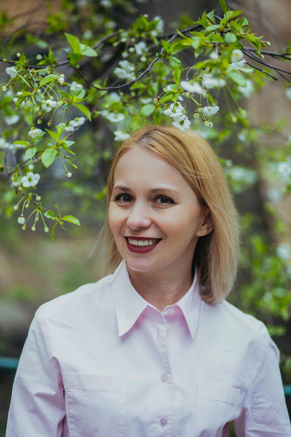 smiling woman in white dress shirt