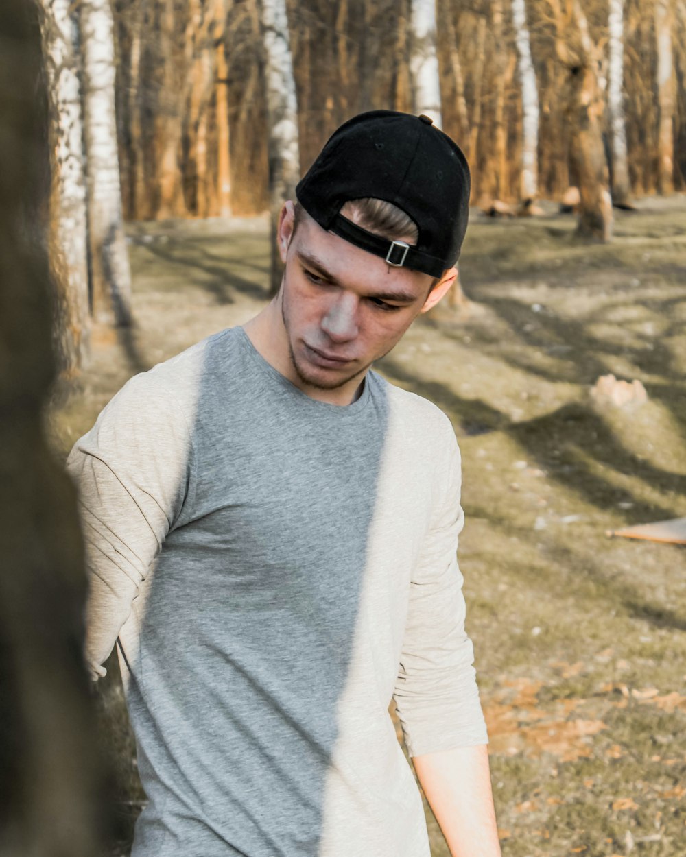 man in gray crew neck long sleeve shirt wearing black sunglasses