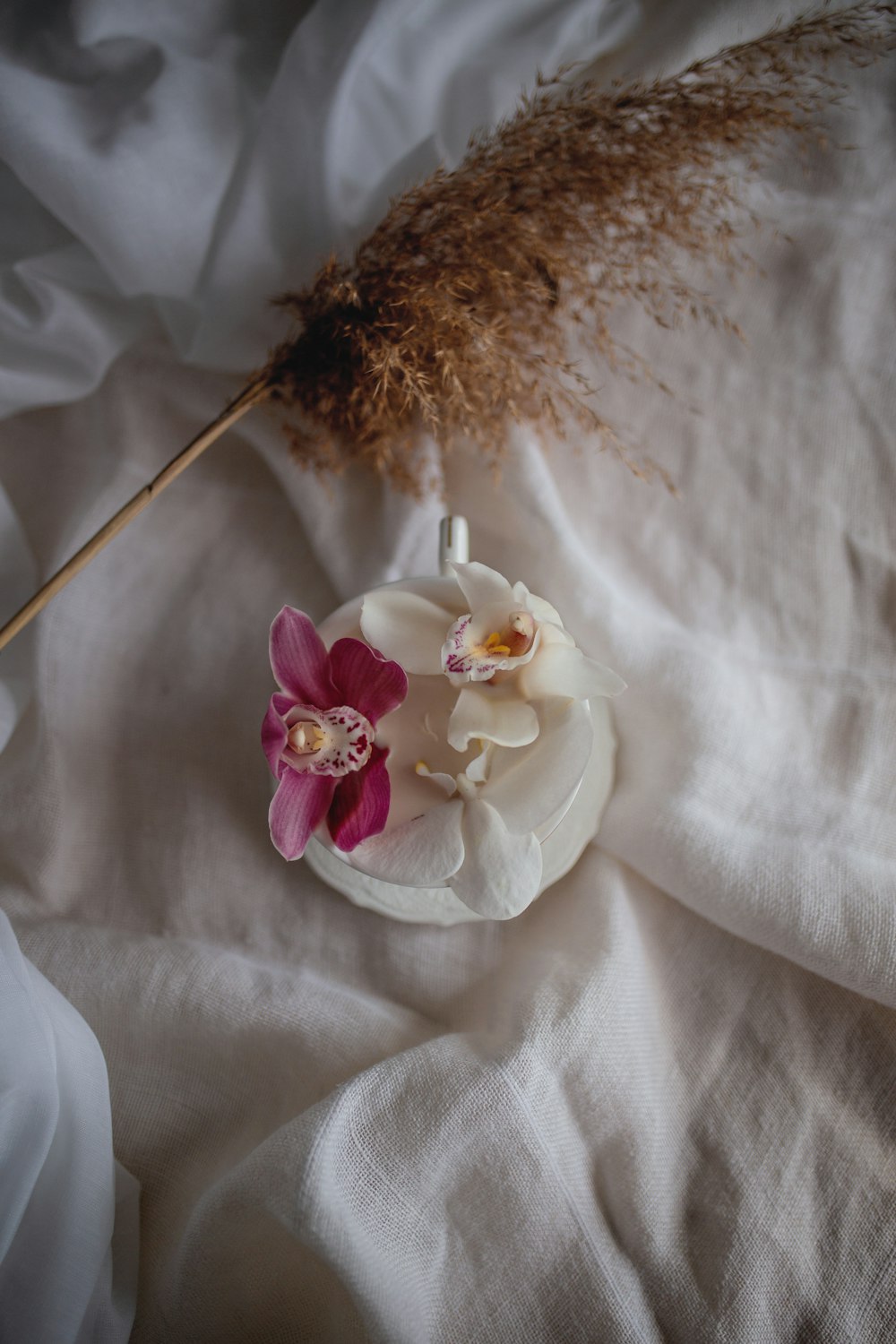 white and purple flower on white textile