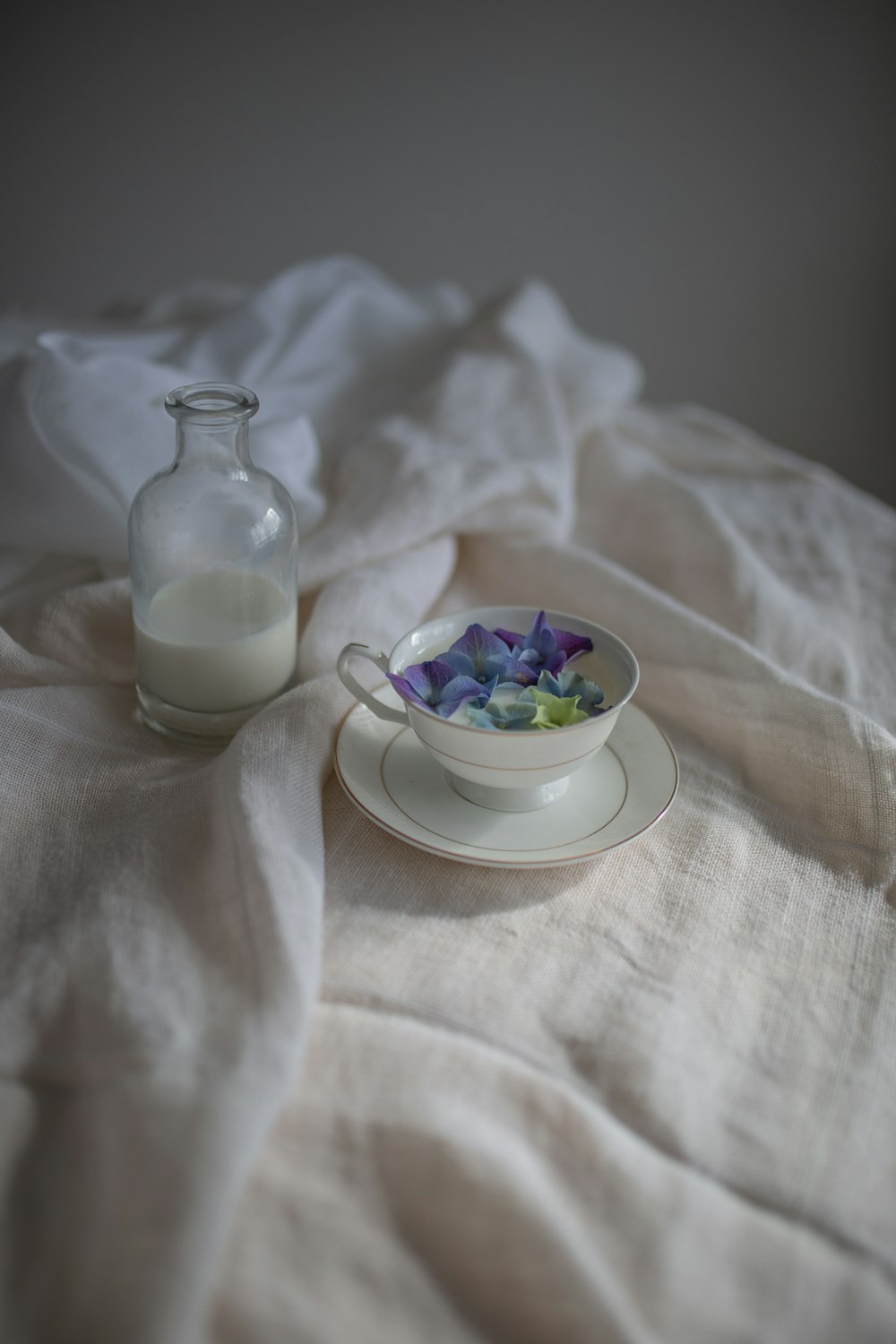 white ceramic bowl with purple flower inside