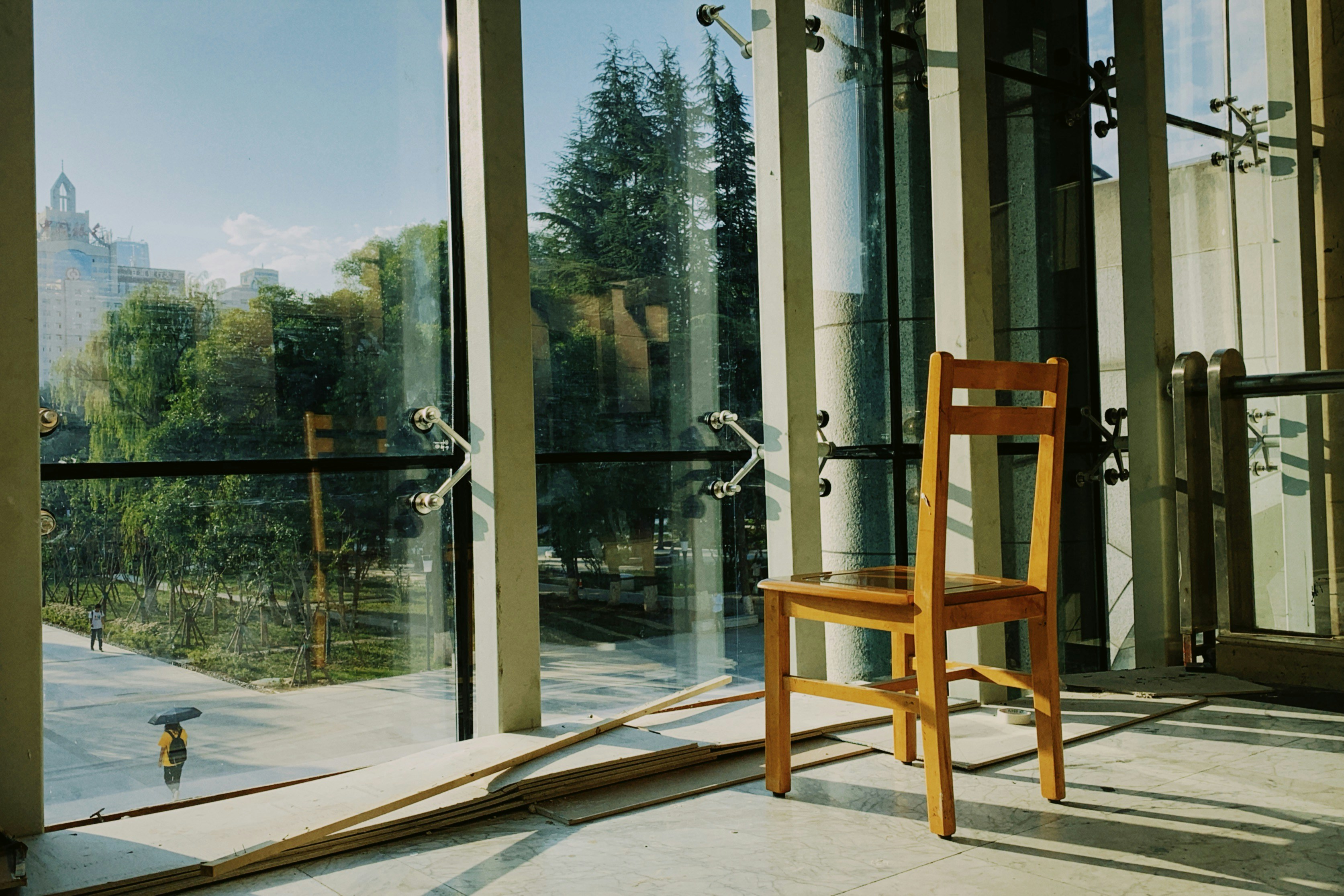 Timber chair beside a glass wall