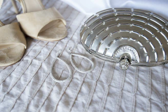 A pair of classic leather heels resting beside a velvet clutch bag.