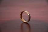 gold ring on brown wooden table