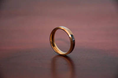 gold ring on brown wooden table