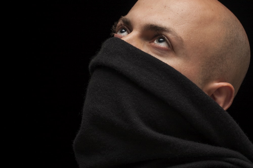 woman covering her face with black textile