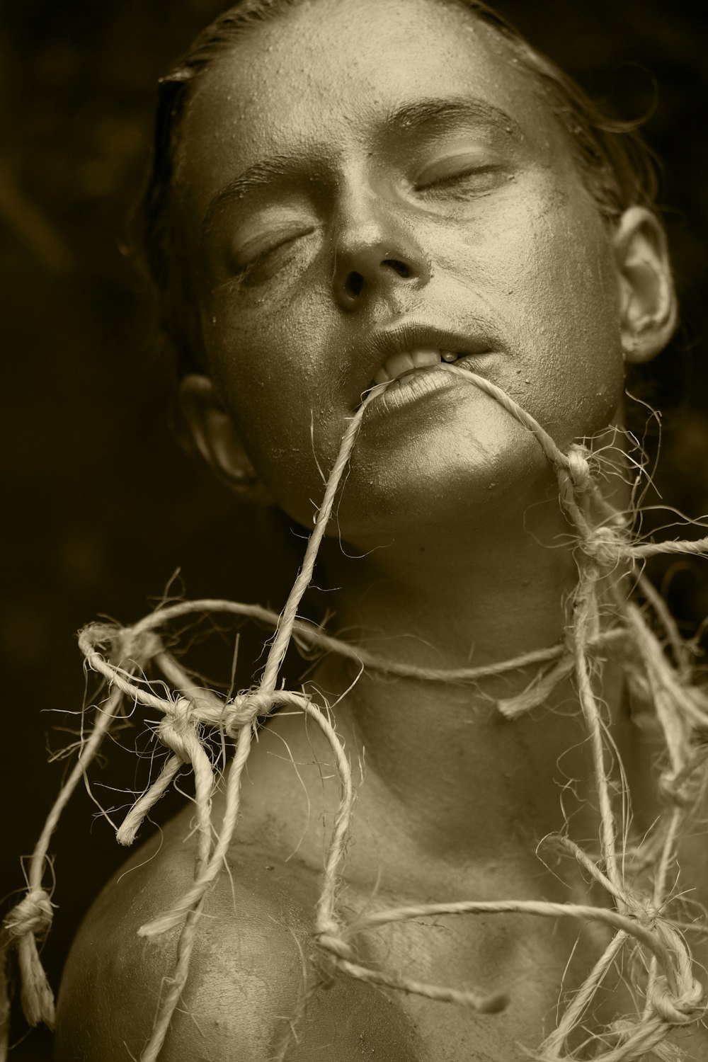 grayscale photo of woman with white flowers on her ear