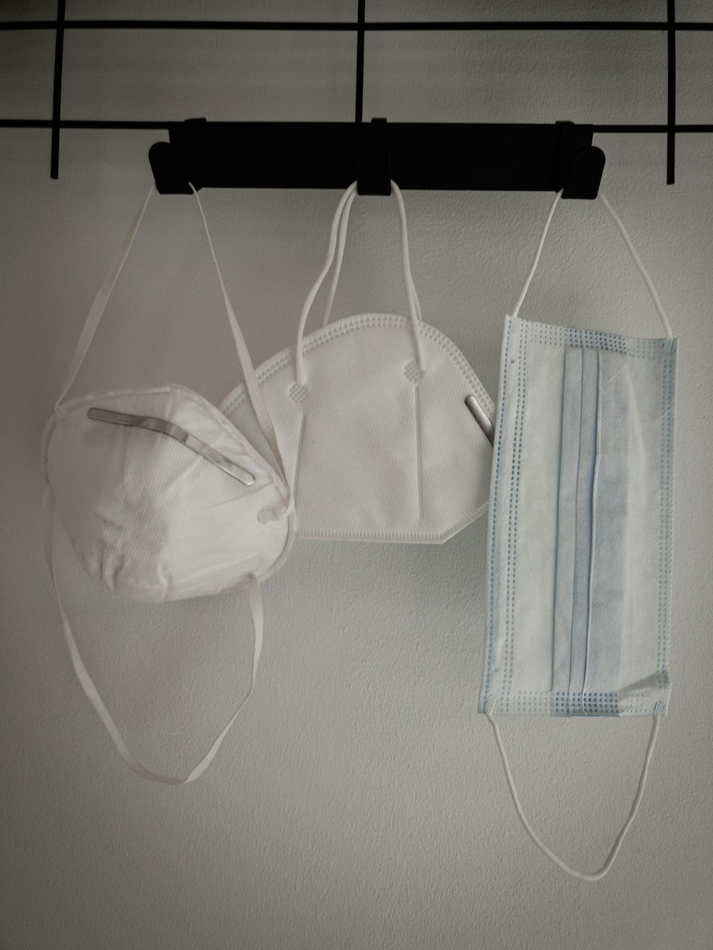 white and blue towel hanging on white wall