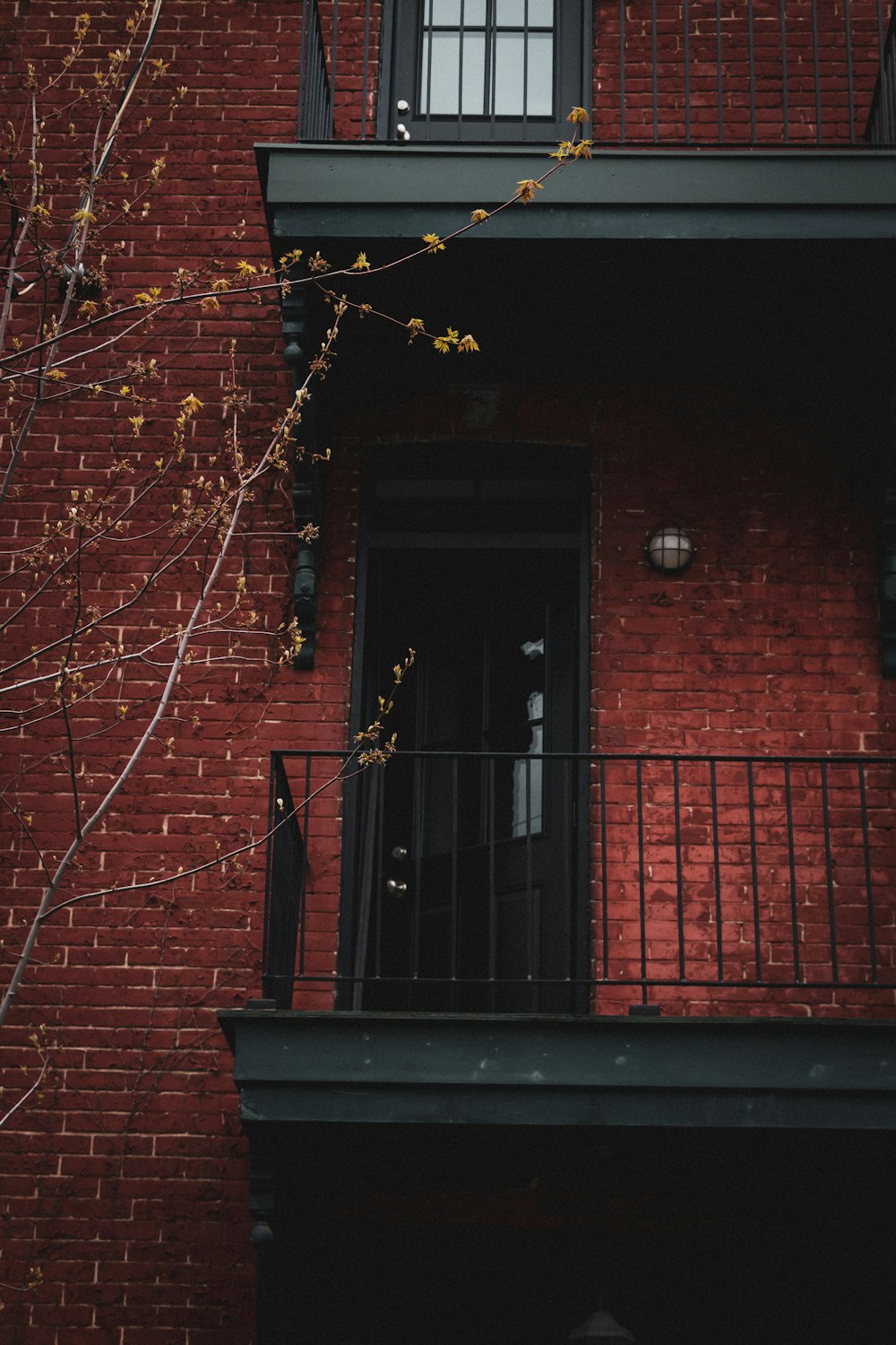 black wooden door on brown brick wall