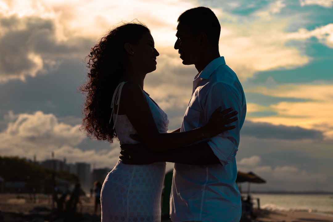 man and woman standing side by side during daytime