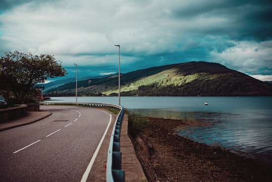 gray concrete road near body of water during daytime in Loch Fyne United Kingdom