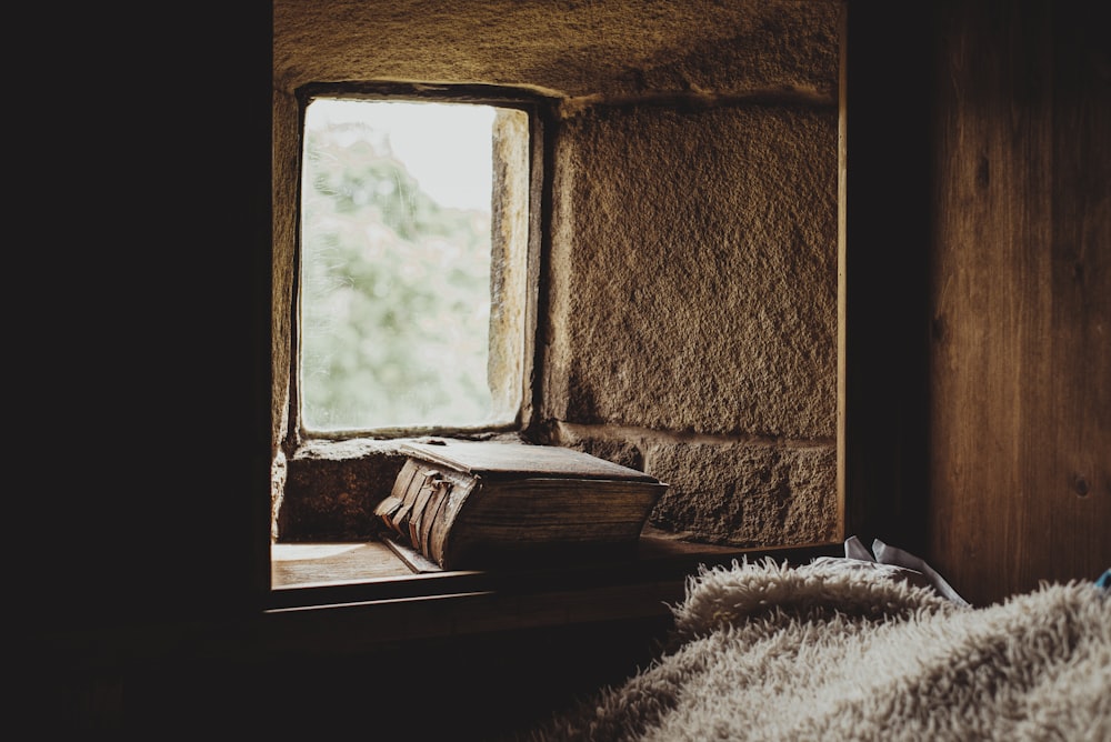 brown wooden table near window