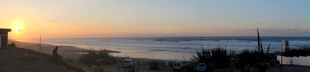 white and black van on beach during sunset
