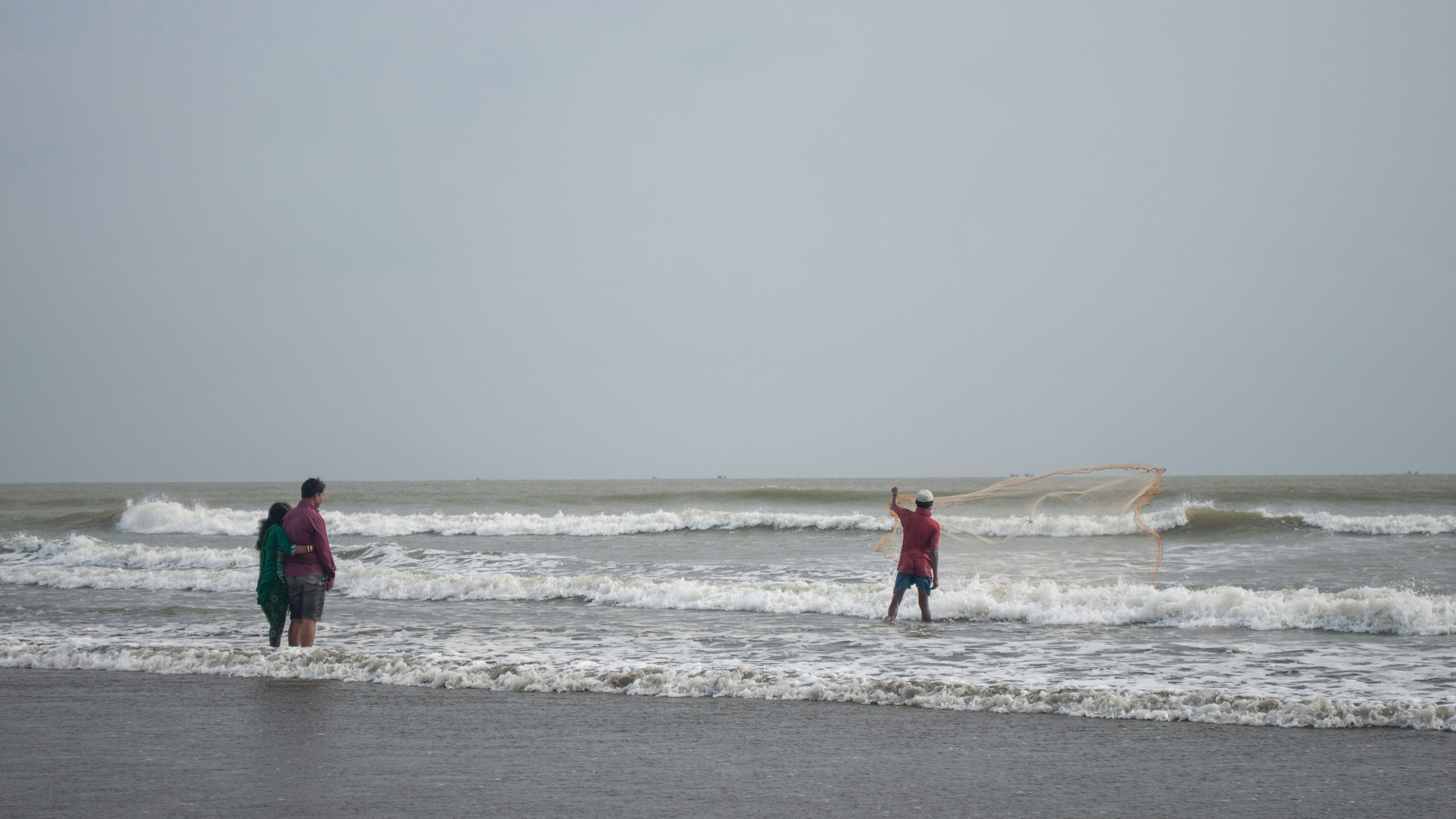 2 women walking on beach during daytime