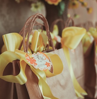 yellow and white ribbon on brown wooden rack