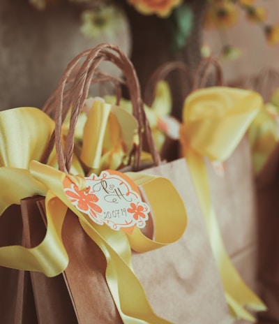 yellow and white ribbon on brown wooden rack