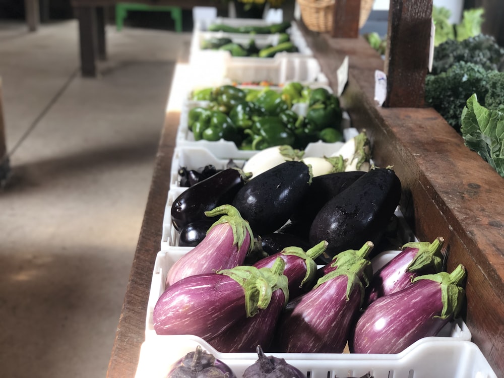 green and purple vegetable on brown wooden tray