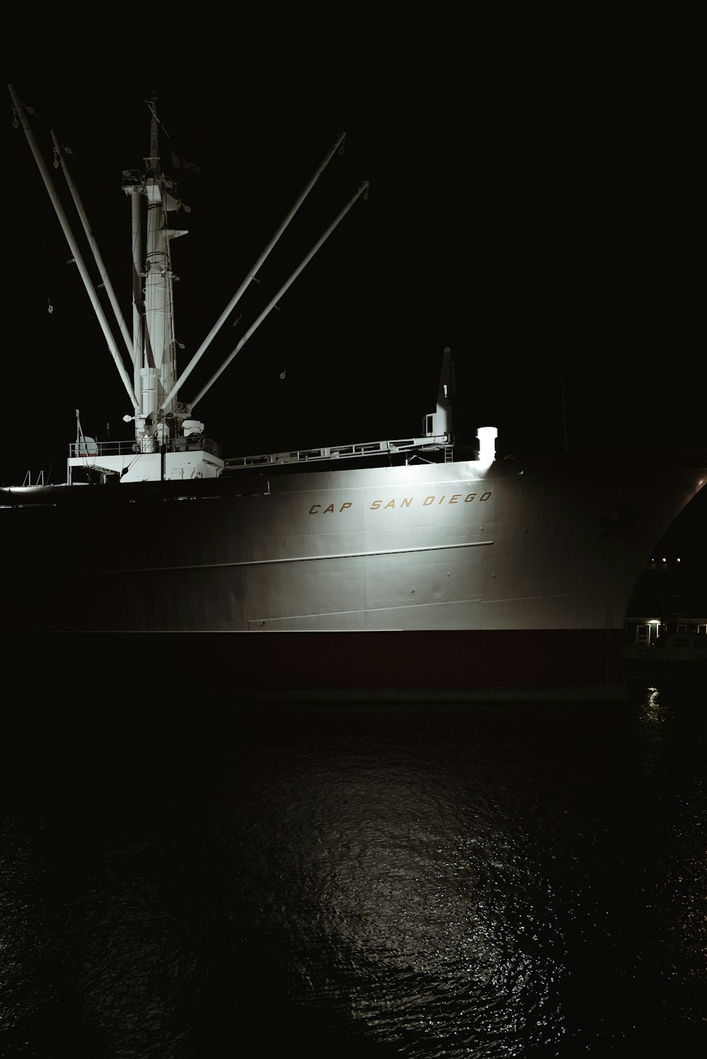 white ship on body of water during night time