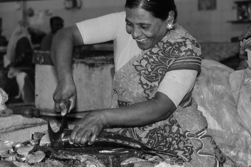 woman in white and black shirt holding knife