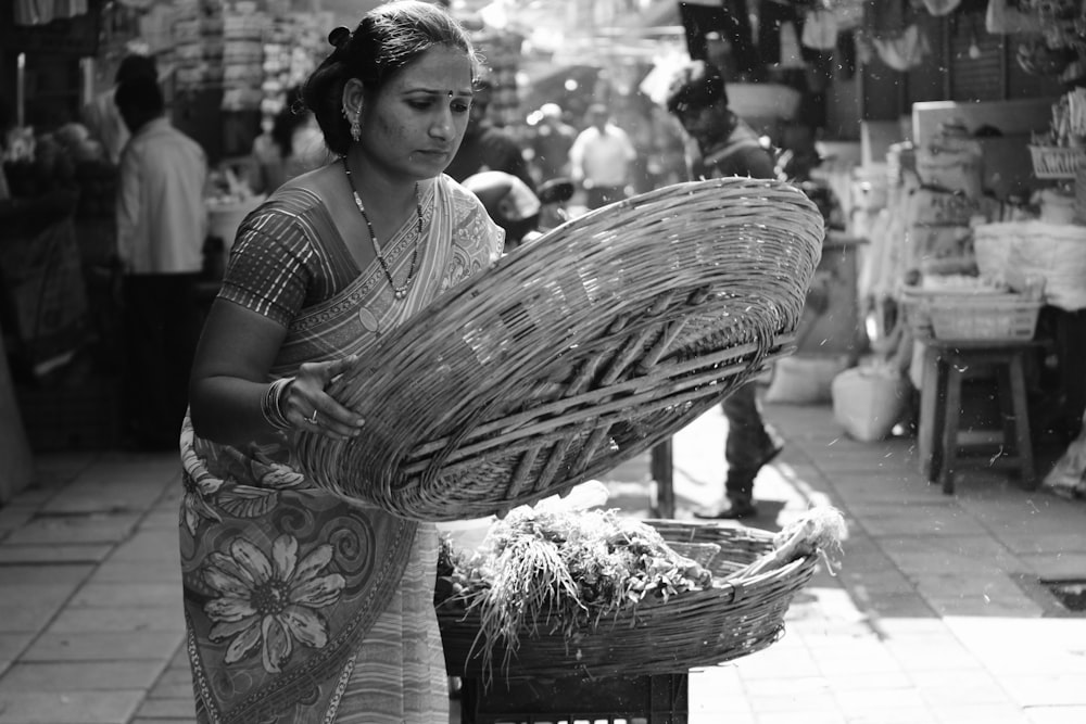 woman in white and black dress holding woven basket