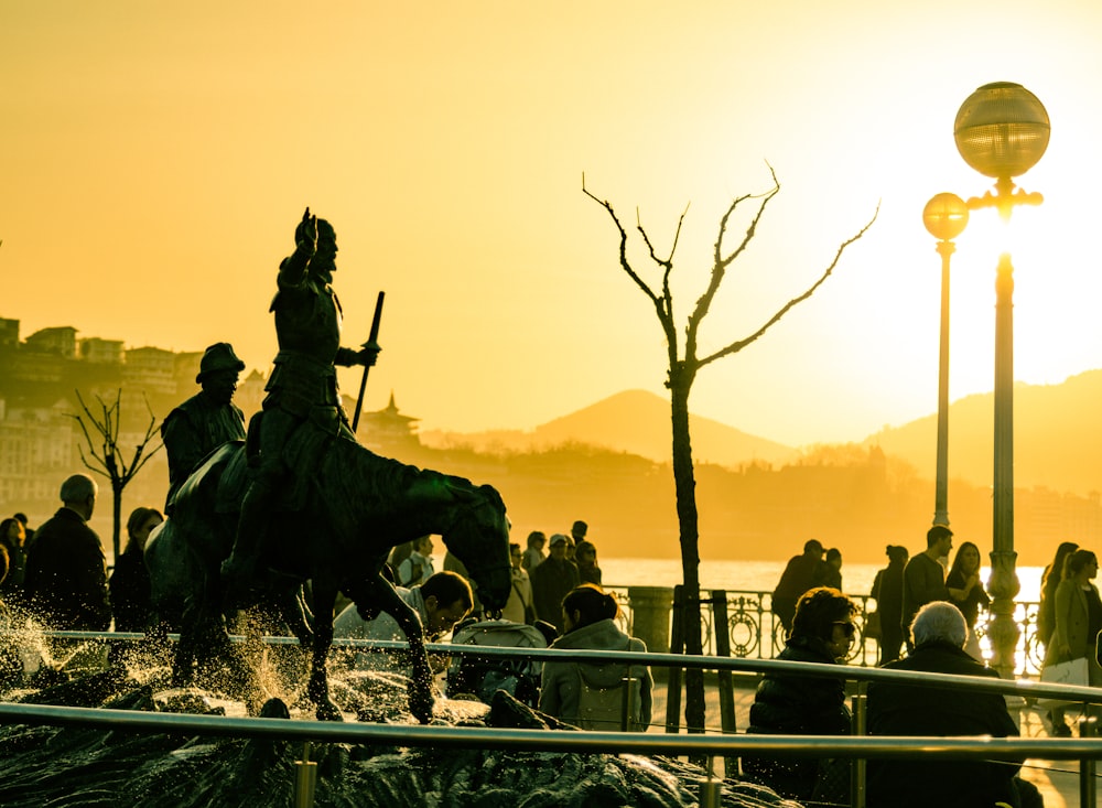 silhouette of people on bridge during sunset