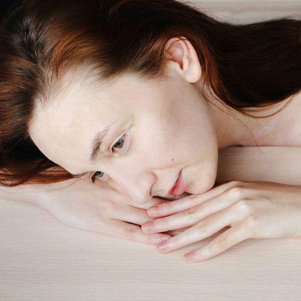 woman lying on white bed