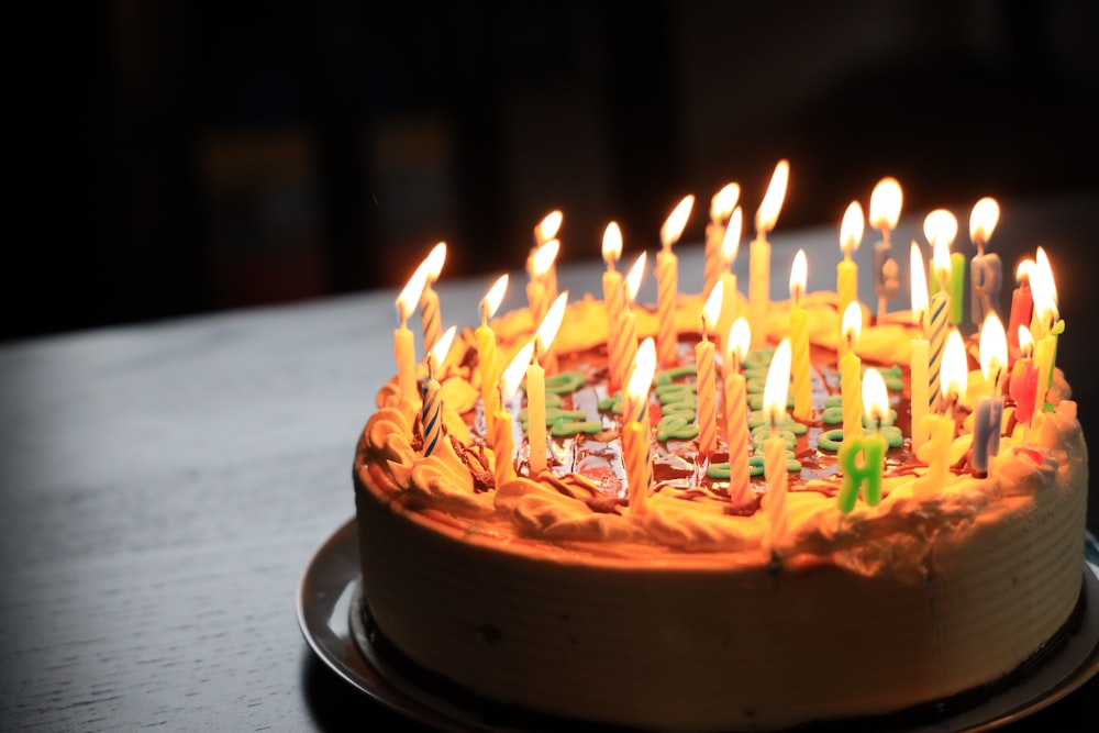 lighted candles on brown cake