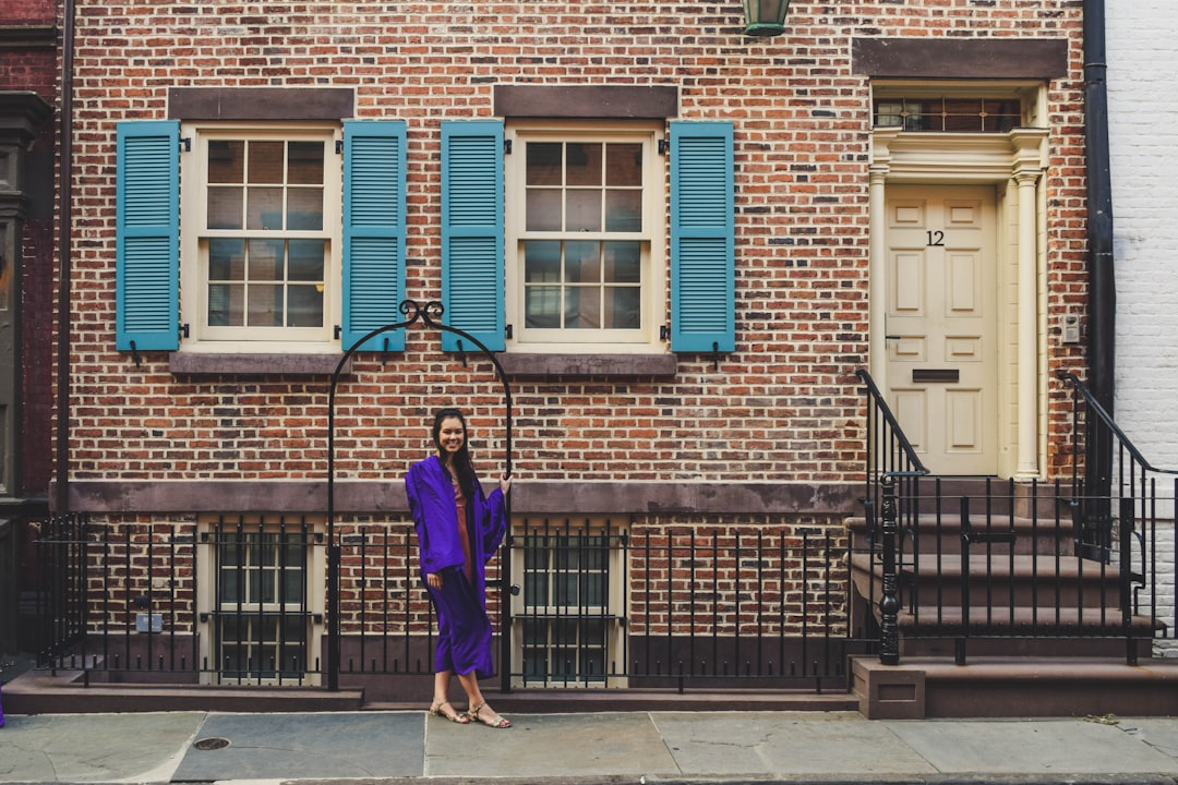 woman in purple long sleeve dress walking on sidewalk during daytime