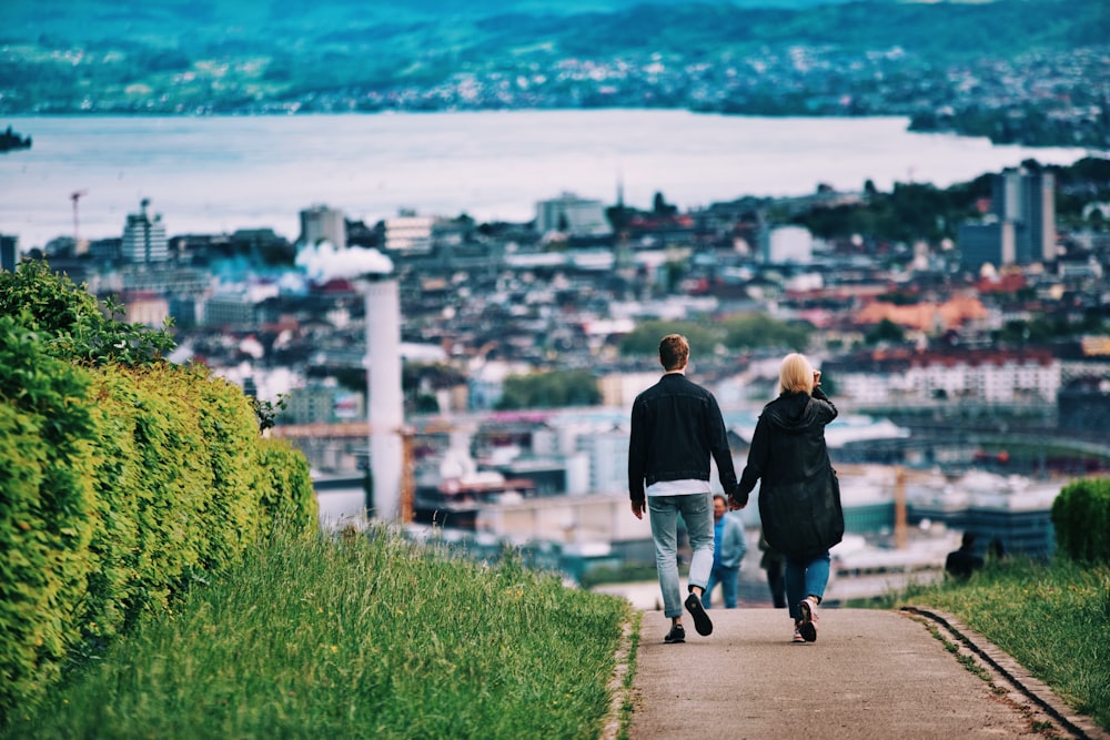 man and woman walking on pathway during daytime