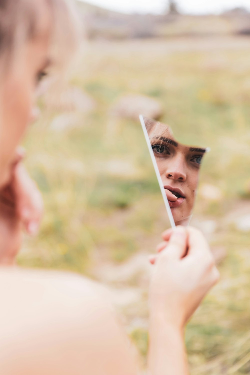 woman in white tank top holding white stick