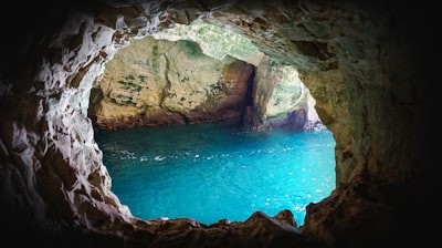 brown rock formation beside blue sea during daytime rosh hashana google meet background