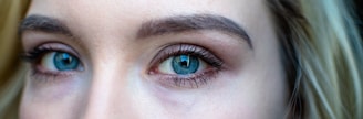 Close-up of long, curled eyelashes with natural makeup.