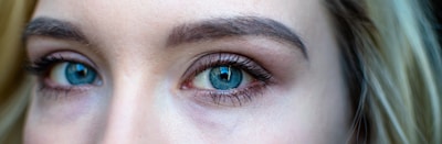 Close-up of long, curled eyelashes with natural makeup.