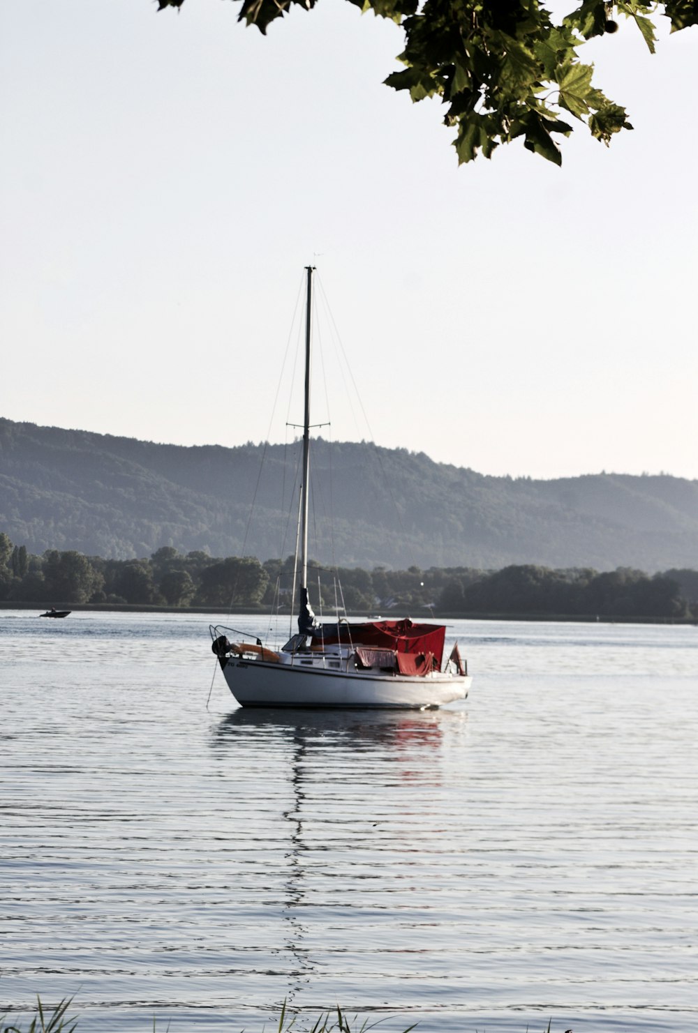 white and red boat on sea during daytime